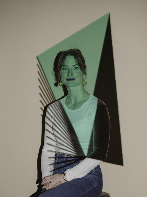 Portrait of Emily Hill with a decorative pattern projected onto her