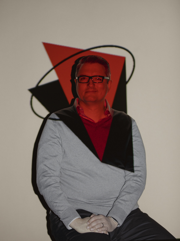 Portrait of Jason Griffin with a decorative pattern projected onto him