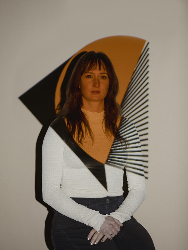 Portrait of Sommer Smith with a decorative pattern projected onto her