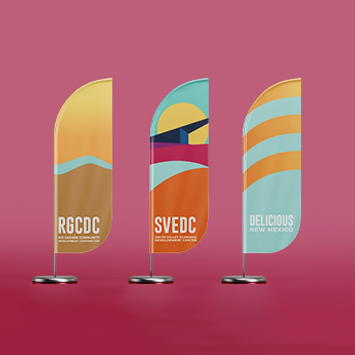 Three branded promotional flags for the Rio Grand Community Development Corporation.