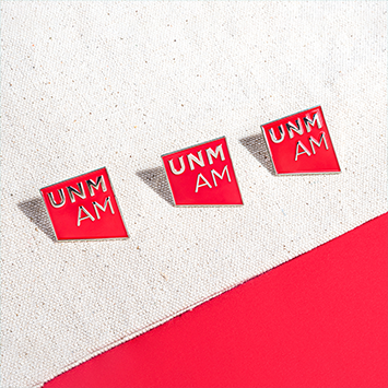 UNM Art Museum logo pinback jewelry.